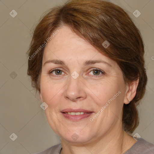 Joyful white adult female with medium  brown hair and grey eyes