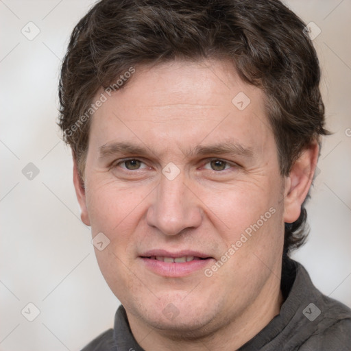 Joyful white adult male with short  brown hair and grey eyes