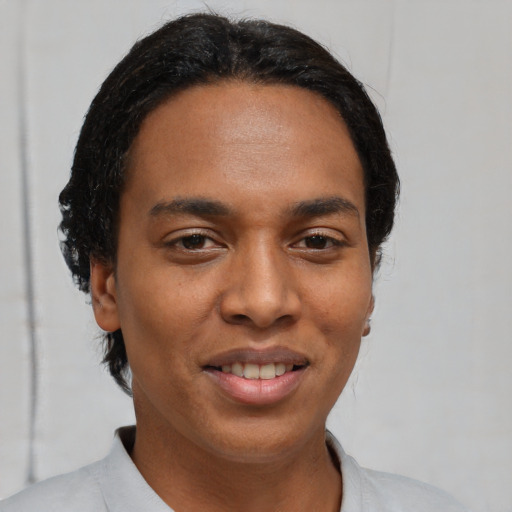Joyful black young-adult male with short  black hair and brown eyes