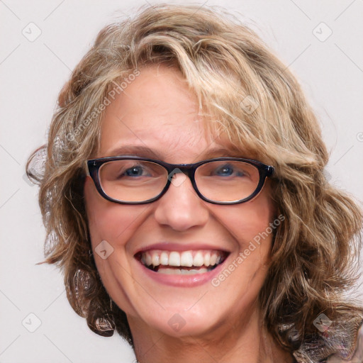 Joyful white adult female with medium  brown hair and blue eyes