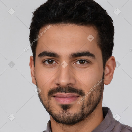 Joyful white young-adult male with short  black hair and brown eyes