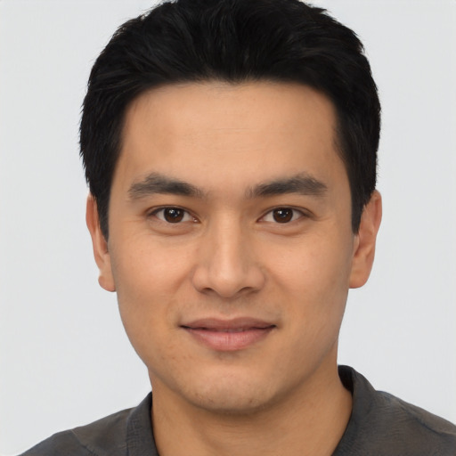 Joyful white young-adult male with short  black hair and brown eyes