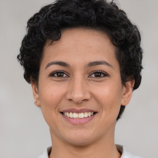 Joyful white young-adult female with short  brown hair and brown eyes