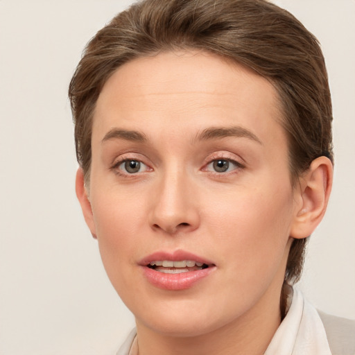 Joyful white young-adult female with short  brown hair and grey eyes