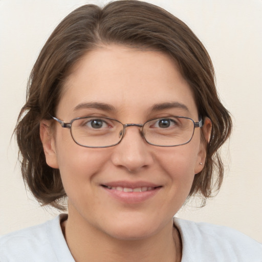 Joyful white adult female with medium  brown hair and brown eyes