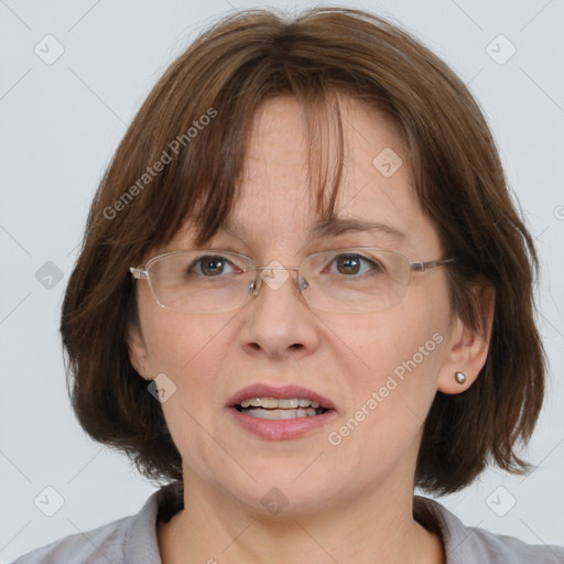 Joyful white adult female with medium  brown hair and blue eyes