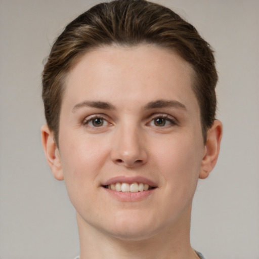 Joyful white young-adult female with short  brown hair and grey eyes