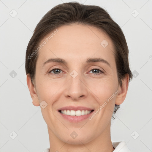 Joyful white young-adult female with short  brown hair and grey eyes