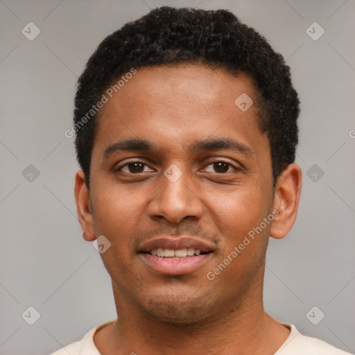 Joyful black young-adult male with short  black hair and brown eyes