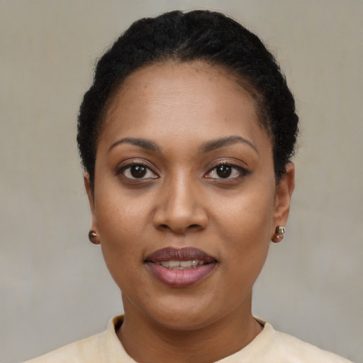 Joyful black young-adult female with short  brown hair and brown eyes