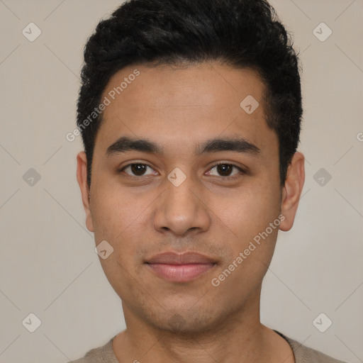 Joyful latino young-adult male with short  black hair and brown eyes