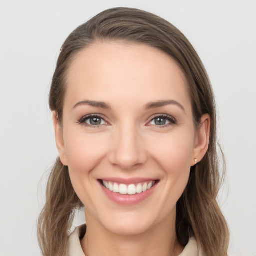 Joyful white young-adult female with long  brown hair and grey eyes