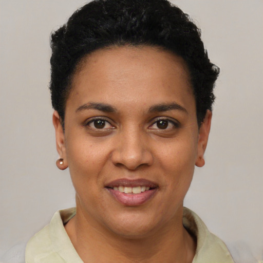 Joyful latino young-adult female with short  black hair and brown eyes