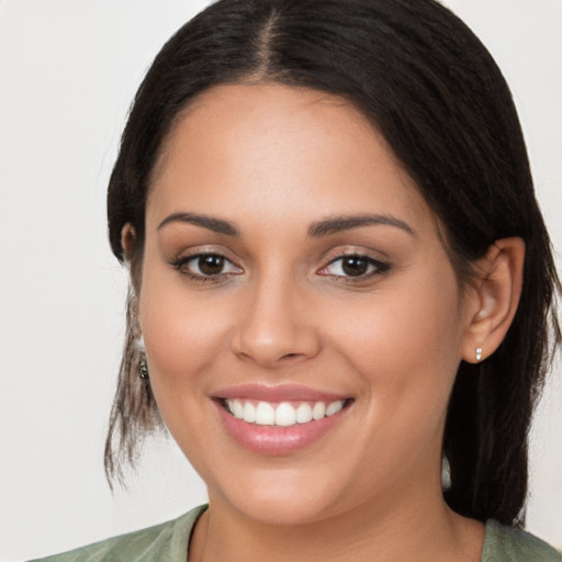 Joyful white young-adult female with long  brown hair and brown eyes