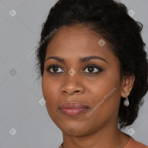 Joyful black young-adult female with long  black hair and brown eyes