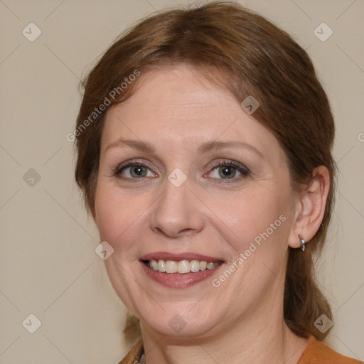 Joyful white adult female with medium  brown hair and blue eyes