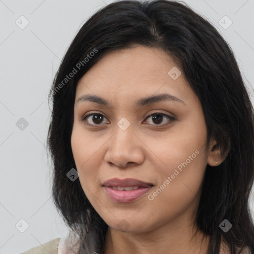 Joyful latino young-adult female with long  brown hair and brown eyes