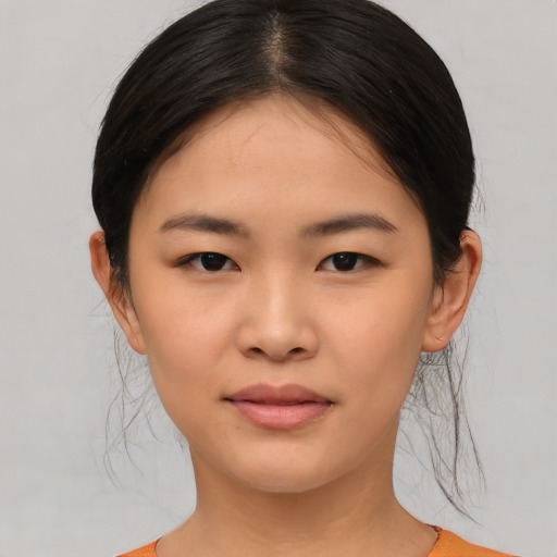 Joyful asian child female with medium  brown hair and brown eyes