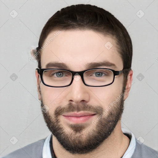 Joyful white young-adult male with short  brown hair and grey eyes