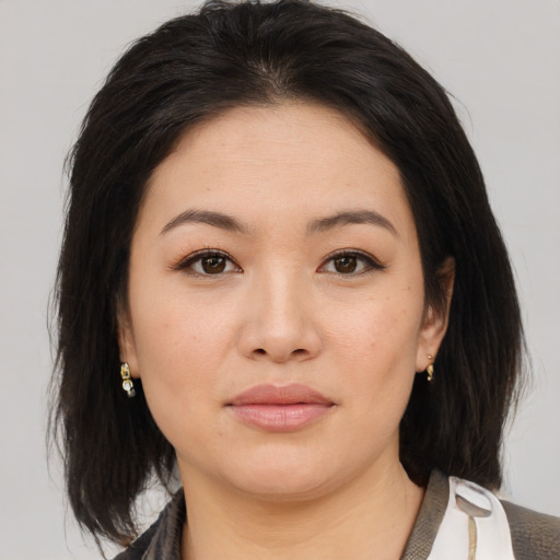 Joyful asian young-adult female with medium  brown hair and brown eyes