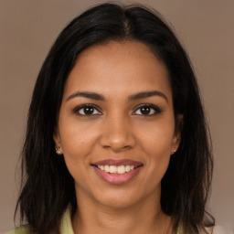 Joyful black young-adult female with long  brown hair and brown eyes