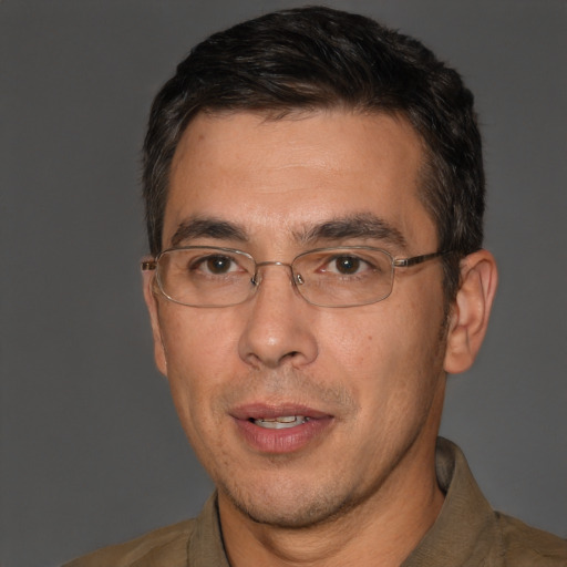 Joyful white adult male with short  black hair and brown eyes