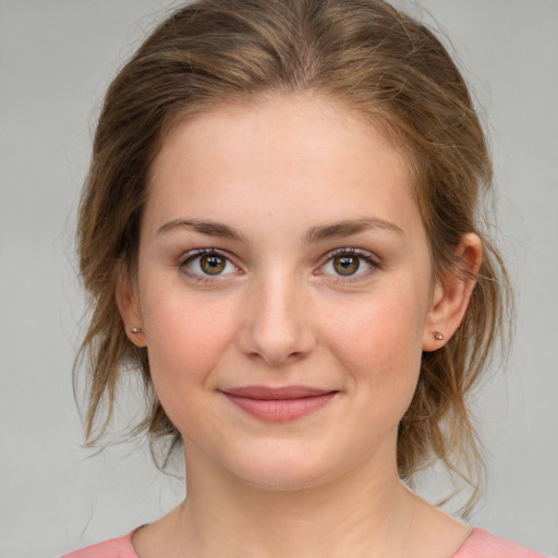 Joyful white young-adult female with medium  brown hair and green eyes