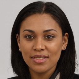 Joyful black young-adult female with long  brown hair and brown eyes