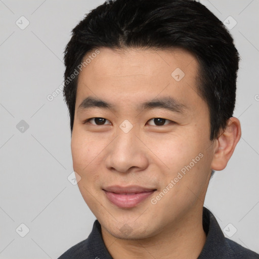 Joyful asian young-adult male with short  brown hair and brown eyes