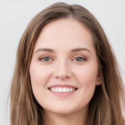 Joyful white young-adult female with long  brown hair and green eyes