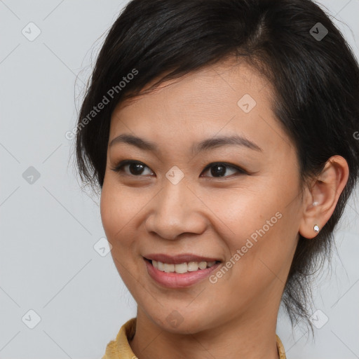 Joyful asian young-adult female with medium  brown hair and brown eyes