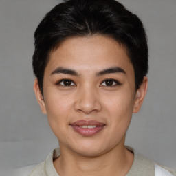 Joyful asian young-adult male with short  brown hair and brown eyes