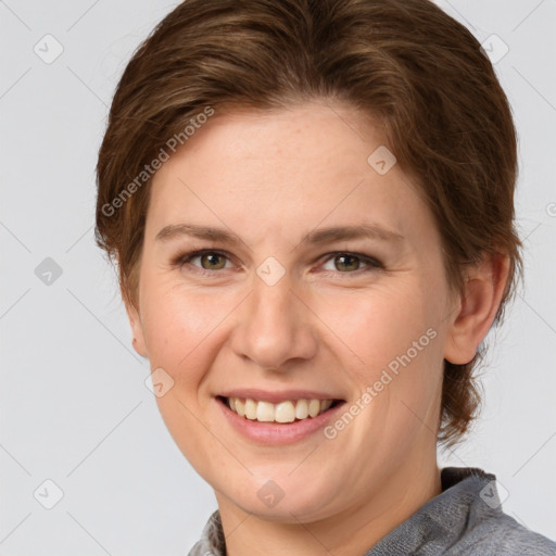 Joyful white young-adult female with medium  brown hair and green eyes