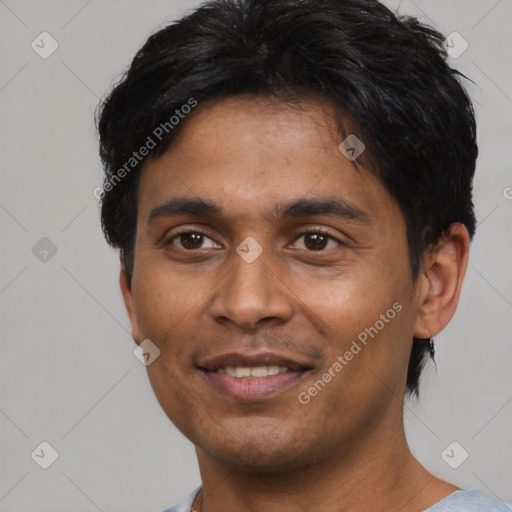 Joyful latino young-adult male with short  black hair and brown eyes