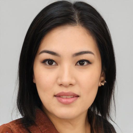 Joyful asian young-adult female with long  black hair and brown eyes