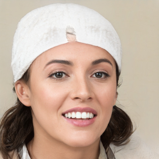 Joyful white young-adult female with medium  brown hair and blue eyes