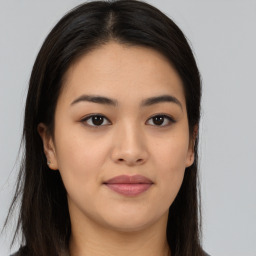 Joyful asian young-adult female with long  brown hair and brown eyes