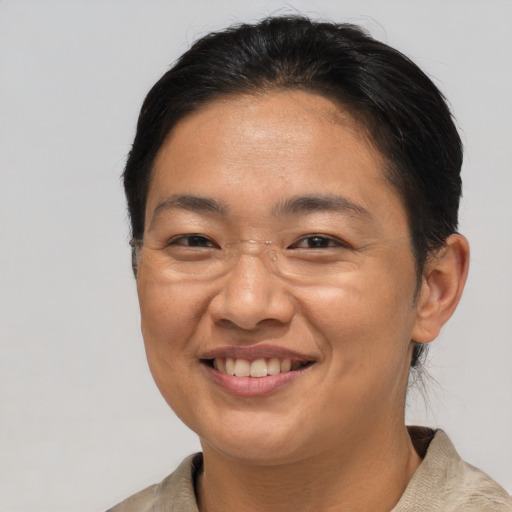 Joyful asian adult female with short  brown hair and brown eyes
