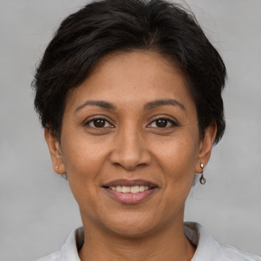 Joyful white adult female with short  brown hair and brown eyes