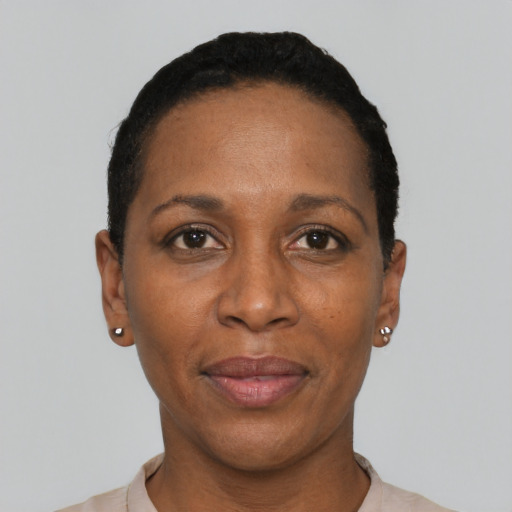 Joyful black adult female with short  black hair and brown eyes