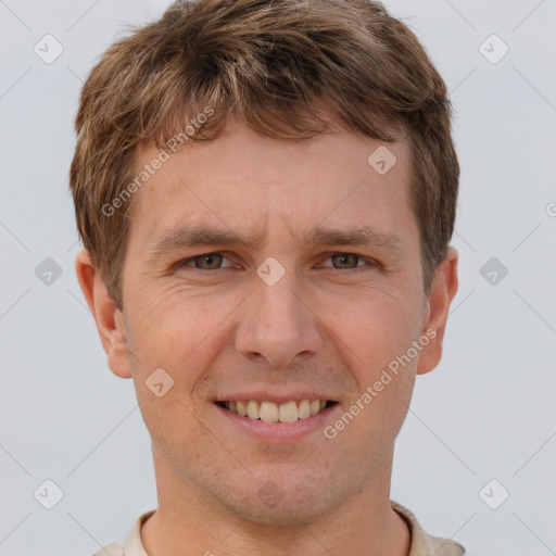 Joyful white adult male with short  brown hair and brown eyes