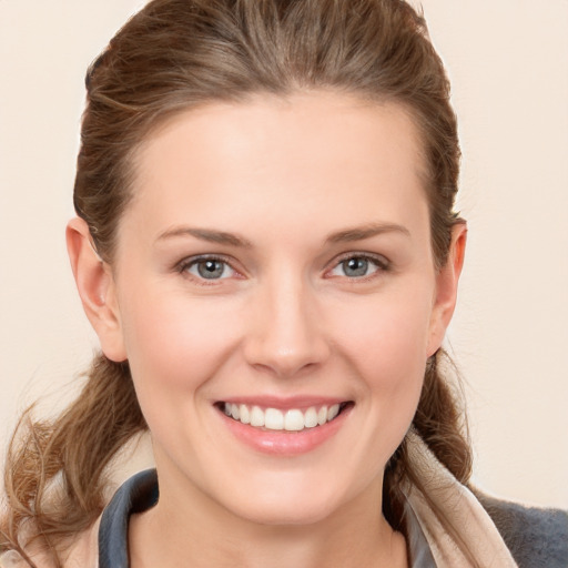 Joyful white young-adult female with long  brown hair and grey eyes