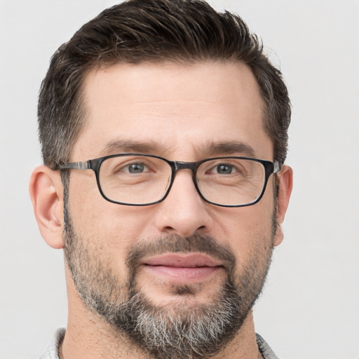 Joyful white adult male with short  brown hair and brown eyes