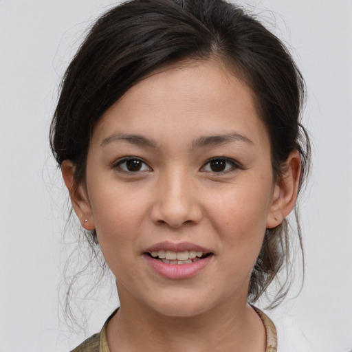 Joyful asian young-adult female with medium  brown hair and brown eyes