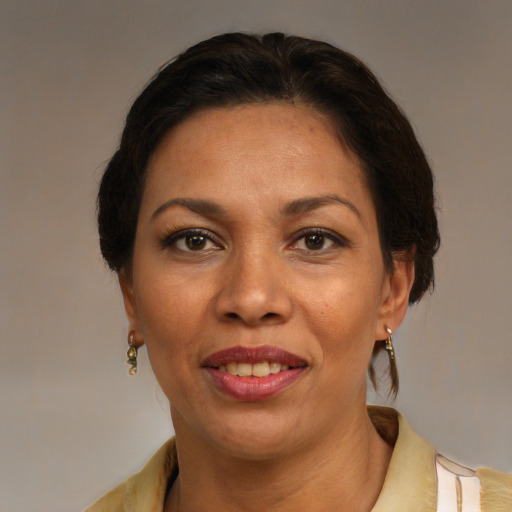 Joyful latino adult female with medium  brown hair and brown eyes