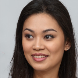 Joyful asian young-adult female with long  brown hair and brown eyes