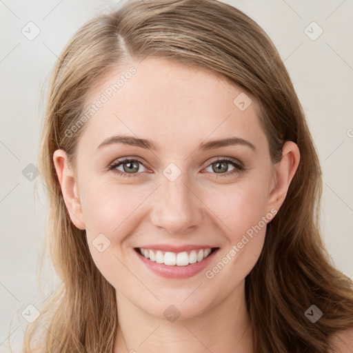 Joyful white young-adult female with long  brown hair and blue eyes