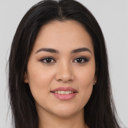 Joyful asian young-adult female with long  brown hair and brown eyes