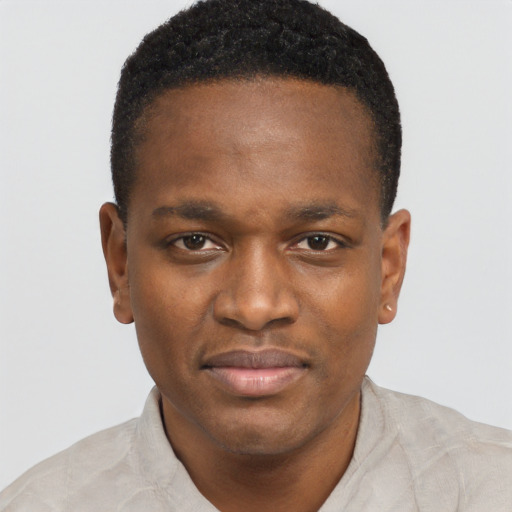 Joyful black young-adult male with short  brown hair and brown eyes