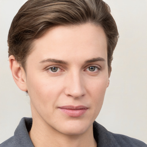 Joyful white young-adult female with short  brown hair and grey eyes